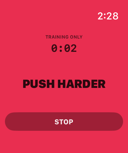 Apple Watch showing PUSH HARDER on a red screen